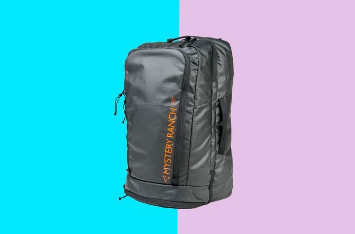 A sleek black travel backpack featuring an orange logo