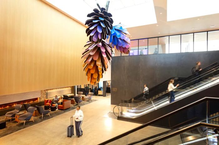 The entrance to United Club B-East showcases a unique artwork piece crafted from repurposed skateboards, resembling pine cones.