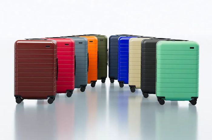 A lineup of 10 Away suitcases showcasing a spectrum of colors