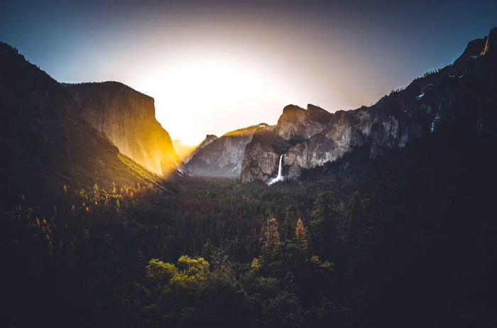 Yosemite Valley featuring a central waterfall