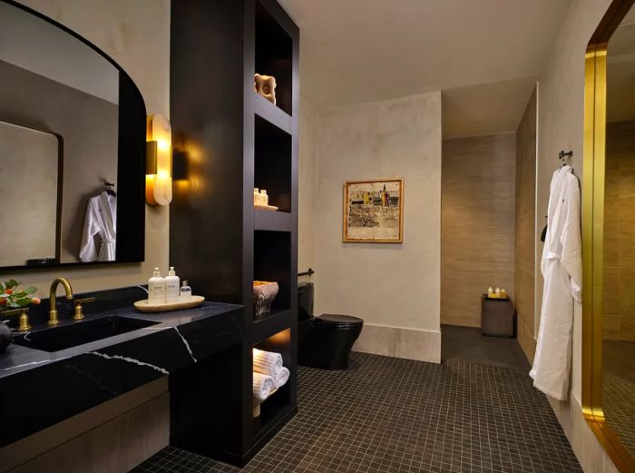 Black and white PS bathrooms featuring a sink, shower, robes, towels, and toiletries.