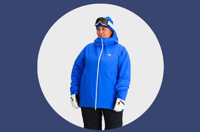 Woman showcasing the Outdoor Research Snowcrew Jacket in Ultramarine