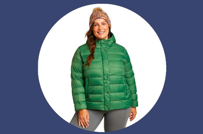 Woman sporting the green Eddie Bauer StratusTherm Hooded Down Jacket