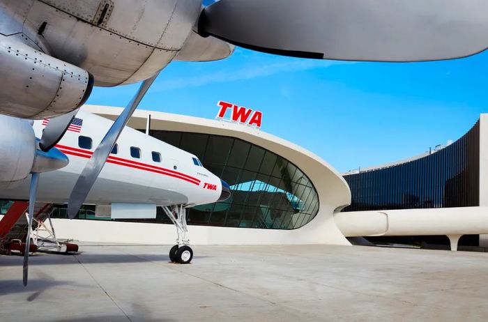 The TWA Hotel features a converted 1958 Lockheed Constellation “Connie” airplane, now serving as a unique cocktail lounge.