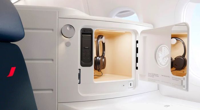 Each seat features a cubby that includes headphones, a mirror, and a USB-C charger.