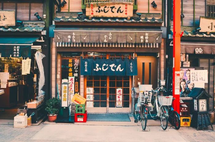 storefront in Tokyo with signs in Japanese and bikes parked outside