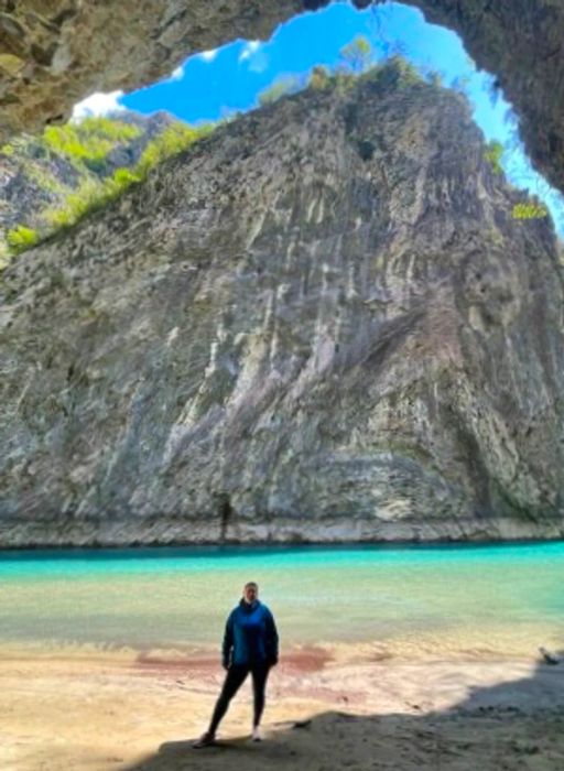 A woman stands by a lake in Albania