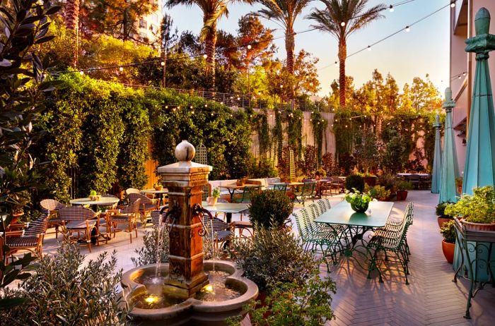 Golden hour on a patio adorned with dining tables and seating.