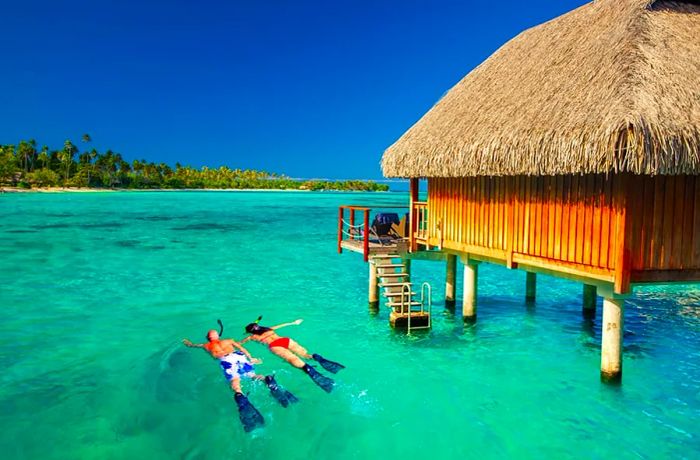 Tourists snorkeling in Bora Bora