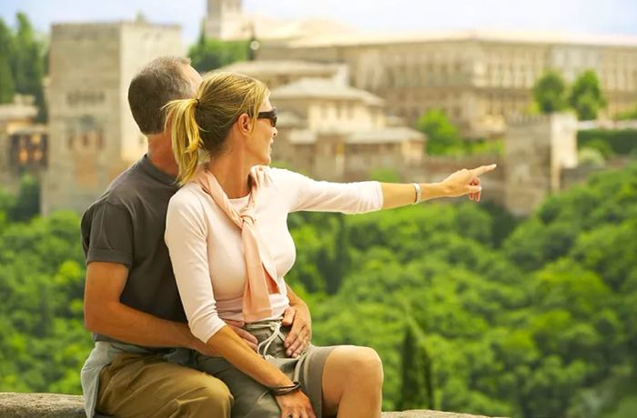 Tourist couple taking in the view of Alhambra, Granada, Spain