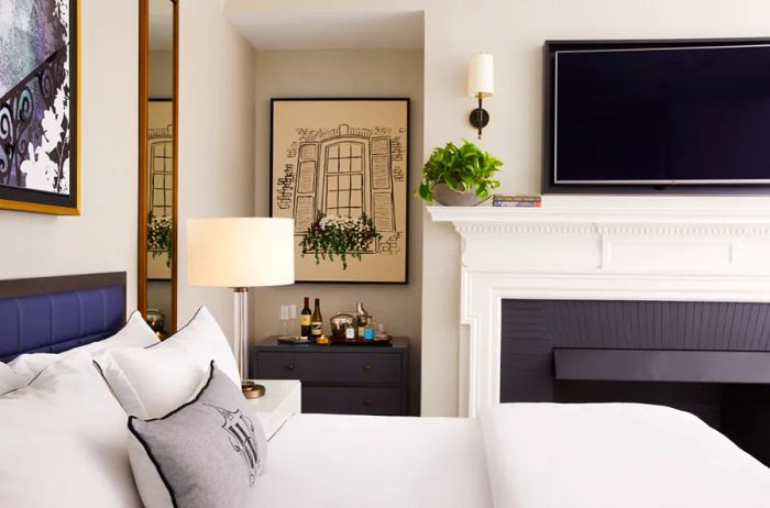 This Premier Suite at the Whitney Hotel includes a fireplace adorned with a white mantle.