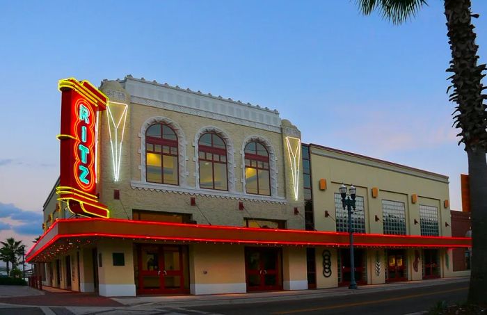 An exterior shot of the Ritz Theatre, featuring its neon red-trimmed awning in Jacksonville, Florida