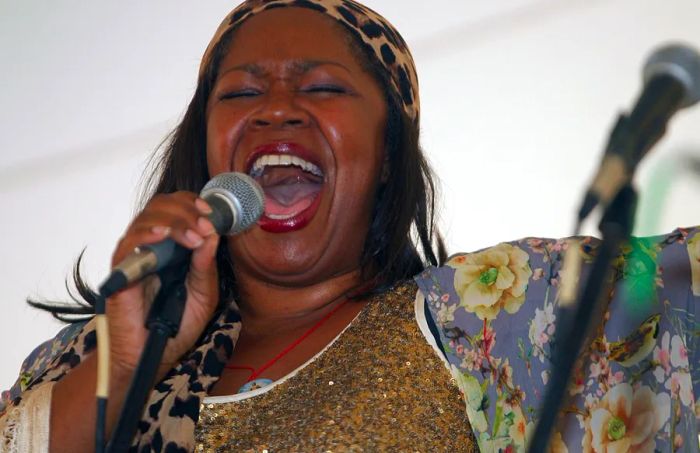 A woman performs with a microphone at The Texas Jazz Festival in Corpus Christi