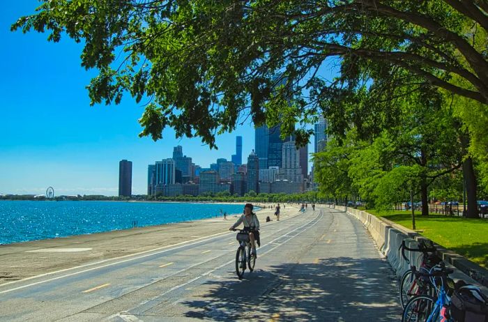 A cyclist rides alongside Lake Michigan on the Chicago Lakefront Trail