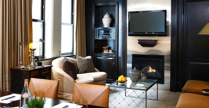 Guest rooms at XV Beacon feature cozy fireplaces and leather-upholstered seating areas.