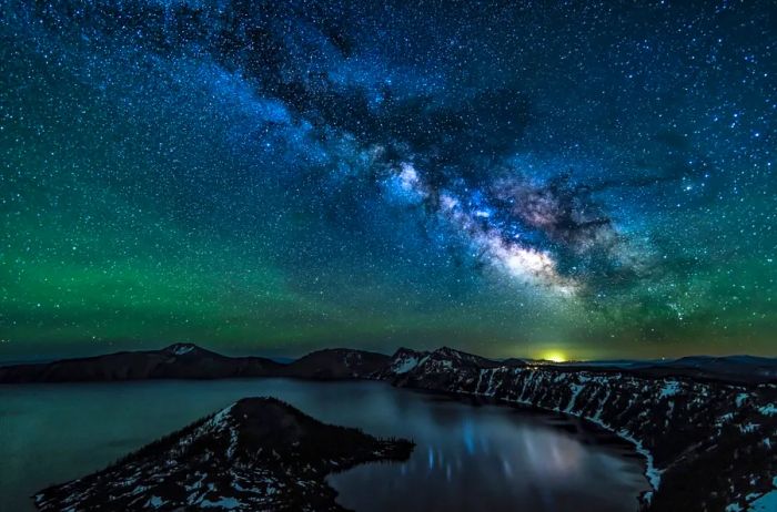 A stunning reflection of stars dances in Crater Lake, captured on the Summer Solstice at Crater Lake National Park, Oregon.