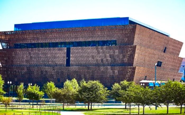 The striking, angular brown façade of the Smithsonian National Museum of African American History and Culture located in Washington, D.C.