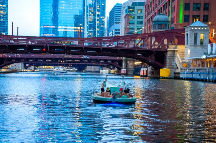 Individuals enjoying a boat ride on a city river