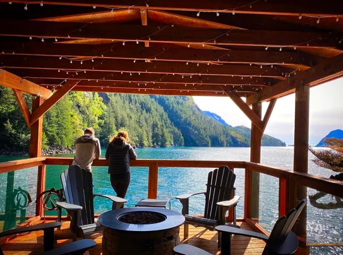 The covered veranda at Orca Island Cabins in Alaska offers stunning waterfront views