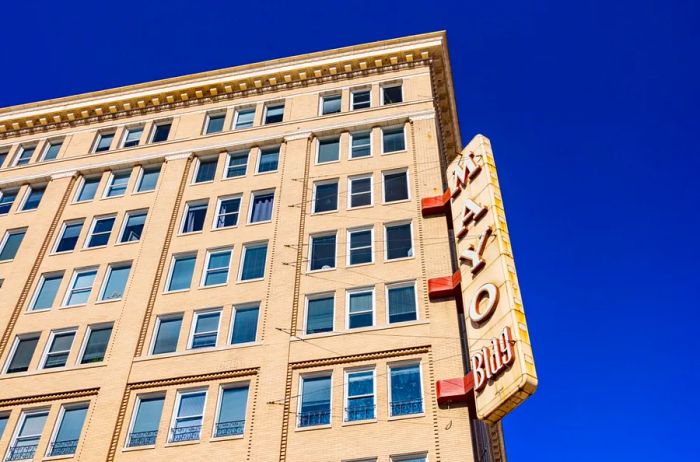 A sunny exterior view of the Mayo Hotel