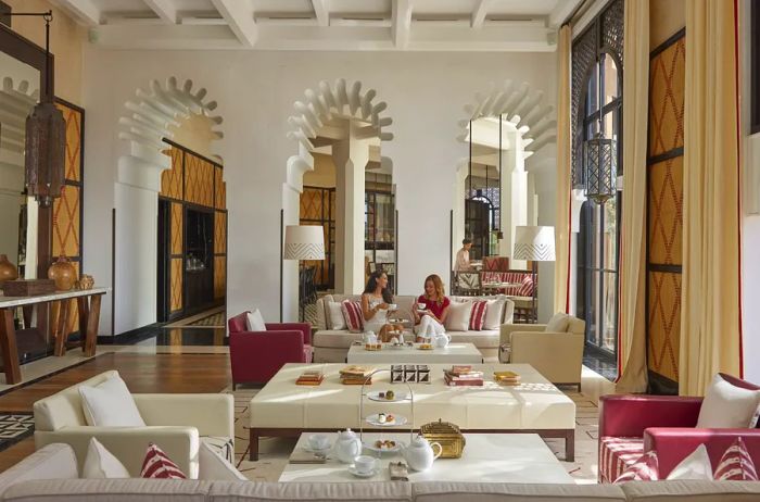 The Salon Berbère at Mandarin Oriental Marrakech boasts elegant white arches and stylish white furnishings.