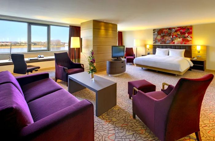 A photograph showcasing a spacious riverside suite at the Hilton Mainz, Germany