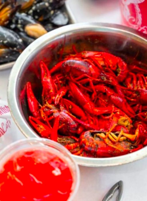 A delightful spread of crawfish, mussels, and a Big Red drink at Crawfish Cafe.