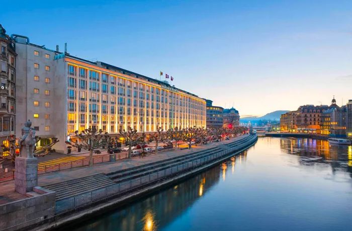 The Mandarin Oriental glows elegantly by the water at dusk.