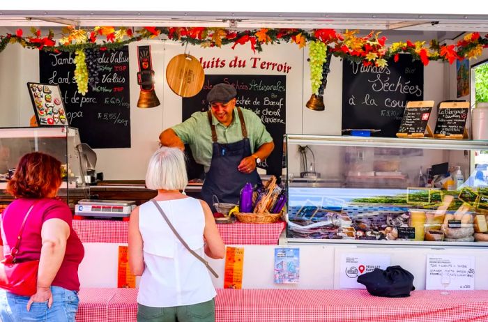 A man at a food stall in a farmers market in Old Town