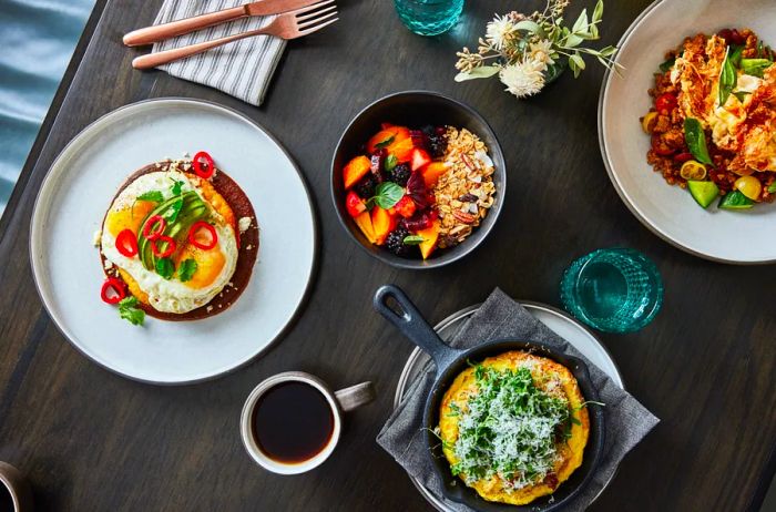 Aerial view of various black and white bowls filled with food