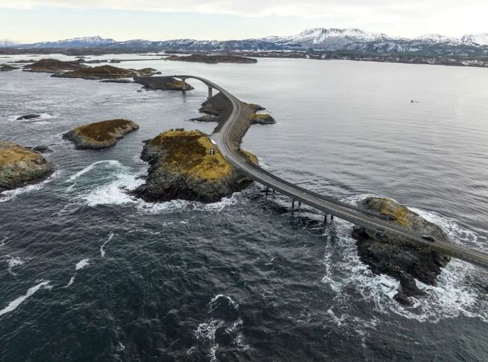 Aerial view of a winding road above the water