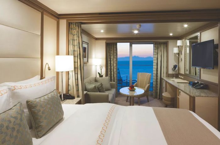 A glimpse of the bed, sitting area, and balcony in a veranda suite aboard Silversea's luxurious 'Silver Spirit' cruise ship