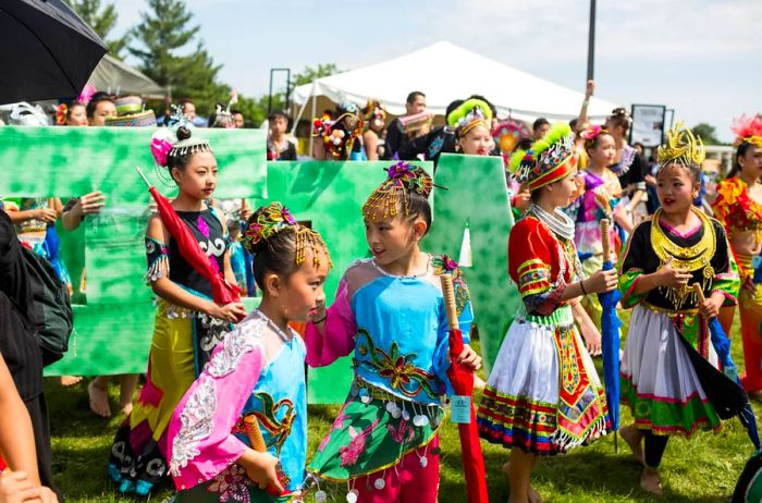 Young Hmong dancers preparing to perform outdoors at the Hmong International Freedom Festival.