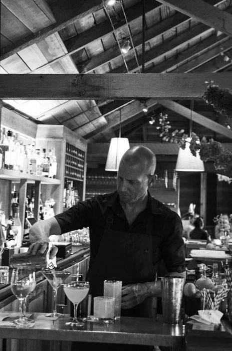 Isaac Levine mixes cocktails at the bar of Angèle.