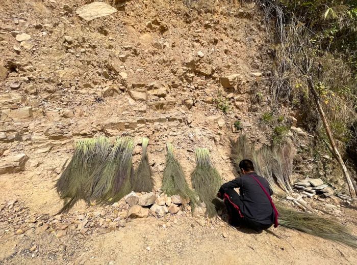 A man crafting brooms near Kongthong Village