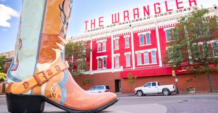 CHEYENNE, Wyoming - APRIL 27, 2018: A sign atop The Wrangler in historic downtown Cheyenne, Wyoming. This three-story red-brick building stands prominently at the intersection of Capitol Avenue and Lincoln Way.