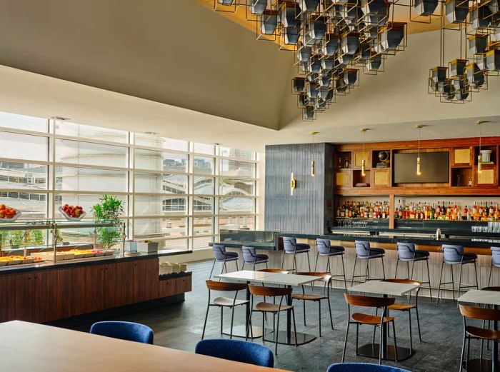 A glimpse of the food buffet and bar area at the AmEx Centurion Lounge in D.C., complete with windows overlooking the airport.