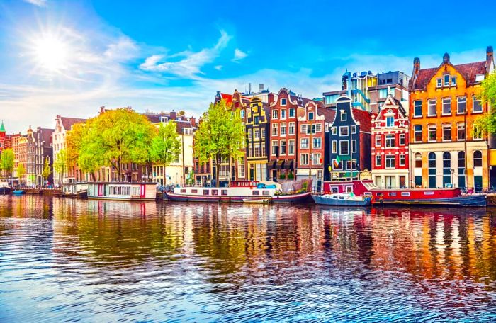 A picturesque Amsterdam canal adorned with vibrant Dutch houses and houseboats.