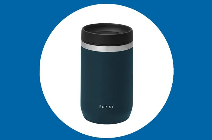 A dark blue Purist Maker Mug featuring a black lid