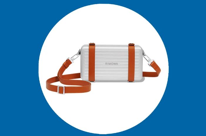 Rectangular Rimowa Personal Crossbody Bag in silver aluminum with tan leather straps