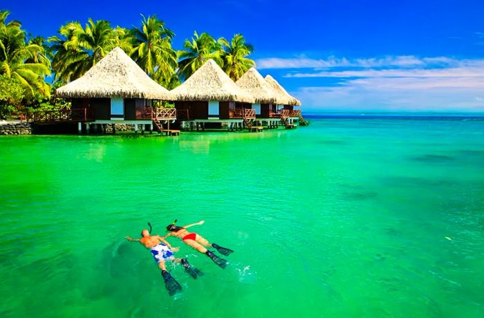 Couple snorkeling near a lagoon in Tahiti