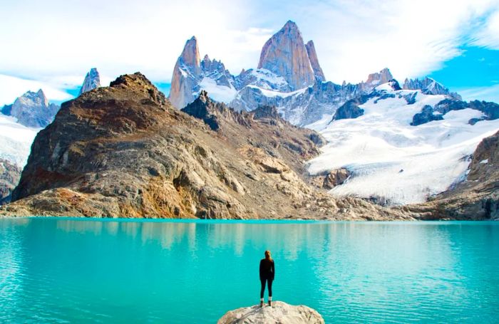 A woman standing by a lake in Patagonia