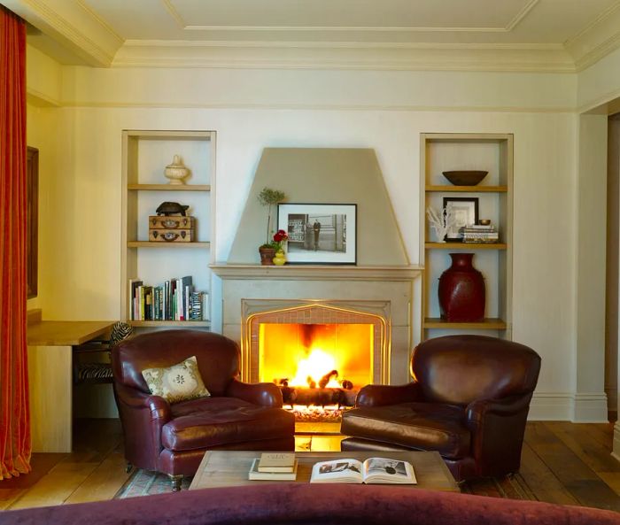 This corner suite at the Greenwich Hotel in New York City features a cozy fireplace surrounded by bookshelves.