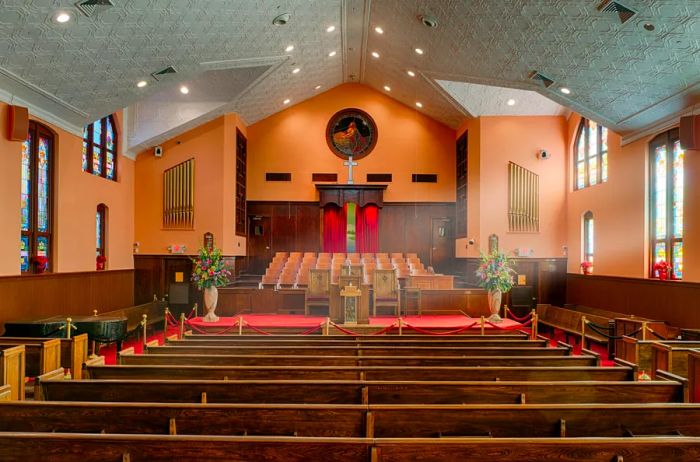 Interior of a church with sunlight streaming through its stained-glass windows