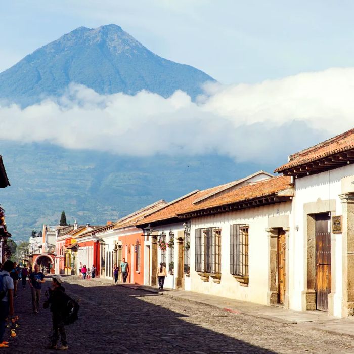 A row of vibrant, multi-colored buildings set against a mountainous backdrop