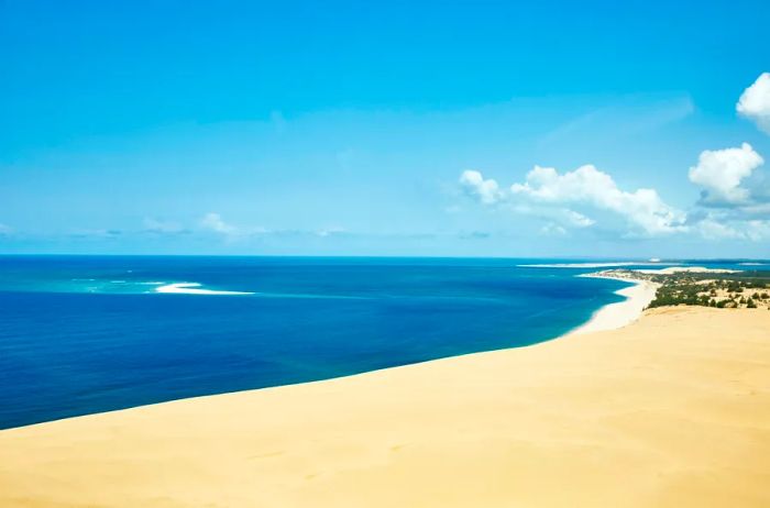 Vivid blue waters contrasting with sandy shores during the day