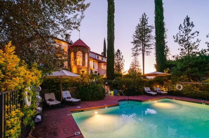 The outdoor pool at Château du Sureau during twilight