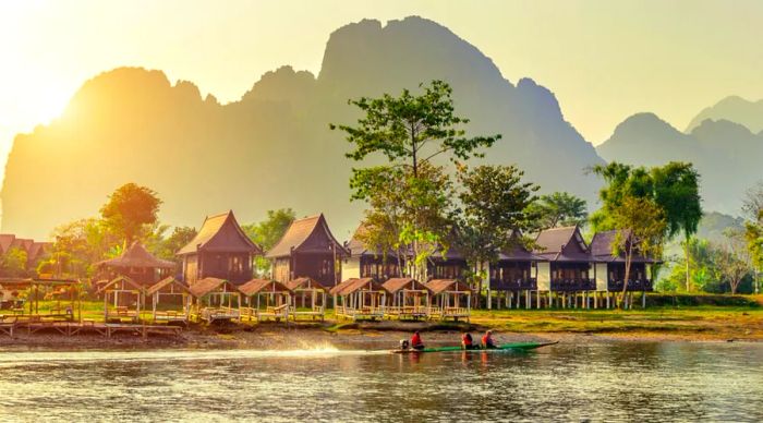 Picturesque village and bungalows lining the Nam Song River in Vang Vieng, Laos.