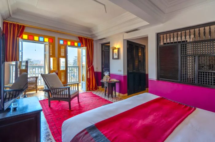 This guest room at L'Heure Bleue is highlighted by vibrant reds.