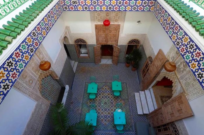 The inner courtyard of Riad Zyo is adorned with vibrant mosaic tiles.